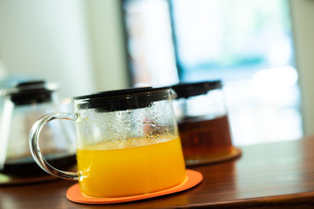 Three glass pots containing tea, coffee, and juice are on the table.の写真素材
