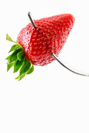 Strawberry on fork on a white background.Vertical imageの写真素材