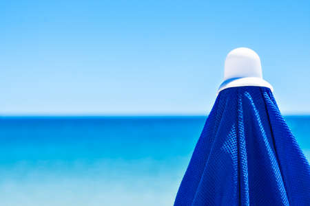 Blue beach umbrella with the sea in the background. Horizontal image.の写真素材