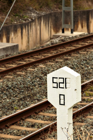 Stone signal in the railway line. Vertical image.