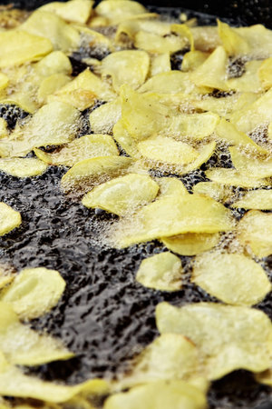 Traditional frying potatoes in a craftsman market.Vertical image.