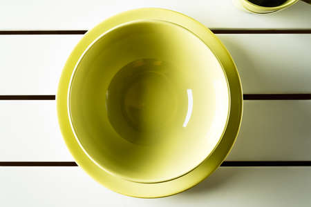 Top view empty green bowl and dish on white wood. Horizontal image.の写真素材