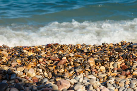 Sea shore with round stones on the mediterranean coast. Horizontal image.の写真素材