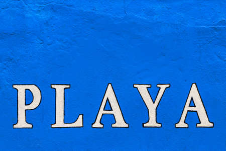 White "playa" sign painted on a blue wall. Horizontal image.の写真素材