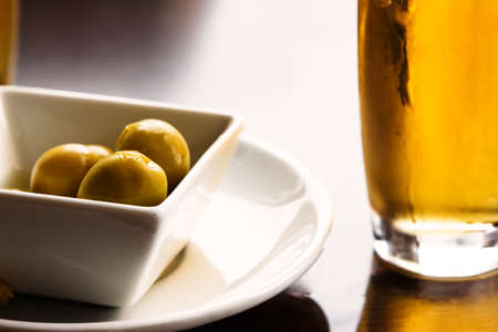 Aperitif with beer and olives. Horizontal image.の写真素材