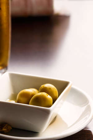 Aperitif with beer and olives. Vertical image.の写真素材