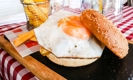 Delicious fried egg sandwich with french fries.の素材