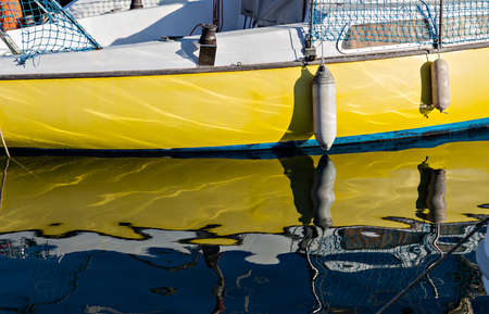 Pleasure boat with reflections in the water in the marina.の写真素材