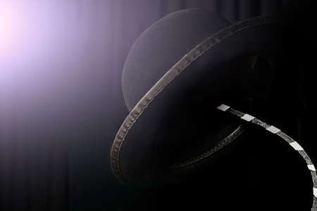 Mime hat on a hanger on black background lit with dramatic light.の写真素材