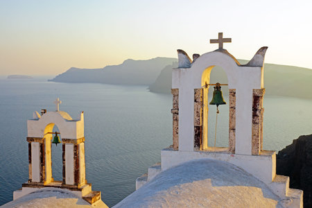 Two belltowers at sunset in Oia, Santoriniの写真素材