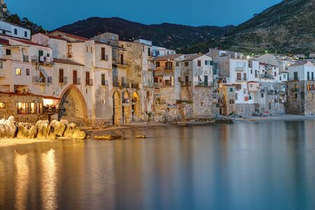 The old town of Cefalu in Sicily Reaches right to the beachの写真素材