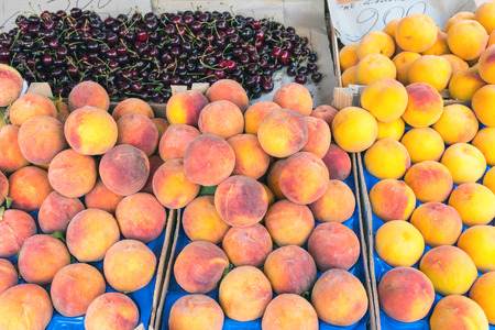 Peaches and cherries for sale at a market in Palermo, Sicilyの写真素材