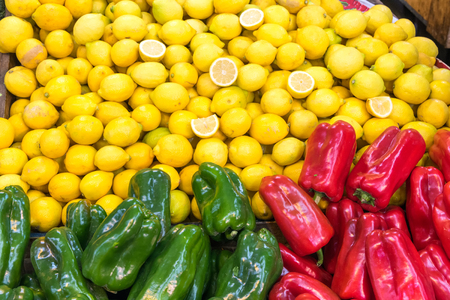 Bell pepper and lemons for sale at a marketの写真素材