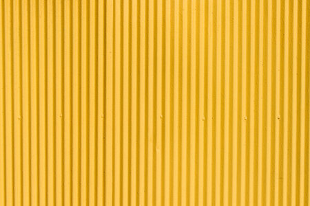 Yellow corrugated metal sheet background and texture surfaceの写真素材