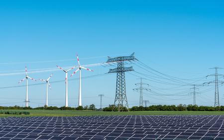 Solar energy panels, wind power and electricity pylons lakes in Germany