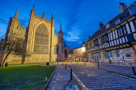 The backside of the York Minster and some half-timbered houses at duskのeditorial素材
