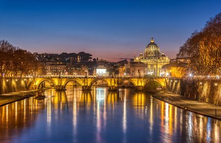 The Tiber river and St. Peters Basilica in the Vatican City, Italy, at twilightの写真素材