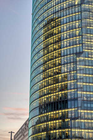 Detail of a highrise office building with illuminated windows at dusk
