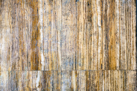 Background from a wall made of brown marble slabs