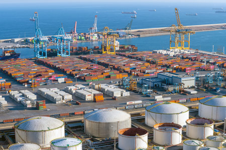 BARCELONA, SPAIN - February 02, 2022: The commercial harbor of Barcelona with containers, cranes and...