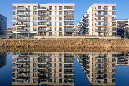 New apartment buildings reflecting in a canal lake in Berlin, Germanyのeditorial素材