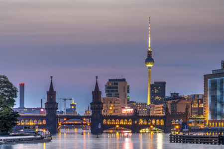 The Spree river in Berlin with the Oberbaum bridge and the TV Tower at twilight