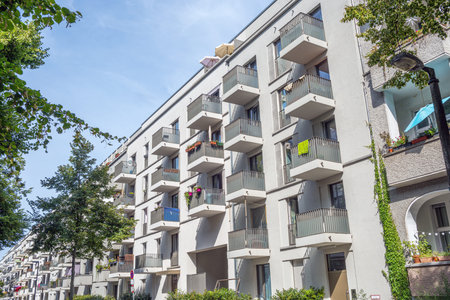 Modern apartment buildings in Berlin, Germany, seen through some trees