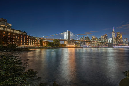The famous Brooklyn Bridge and the skyline of lower Manhattan in New York during blue hour