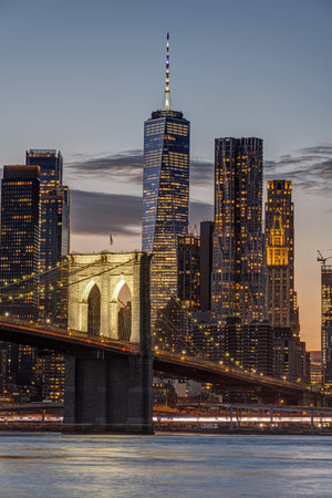 The famous Brooklyn Bridge and the World Trade Center in New York after sunsetの写真素材