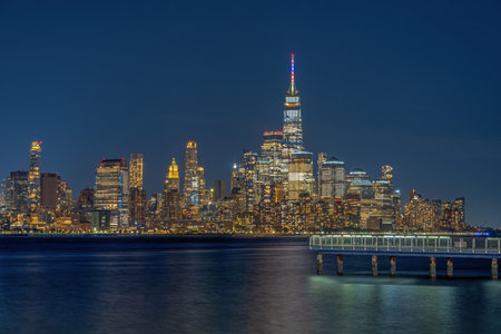 The famous skyline of downtown Manhattan in New York City at nightの写真素材
