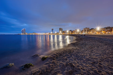 The beach of Barceloneta in Barcelona, Spain, at twilightの写真素材