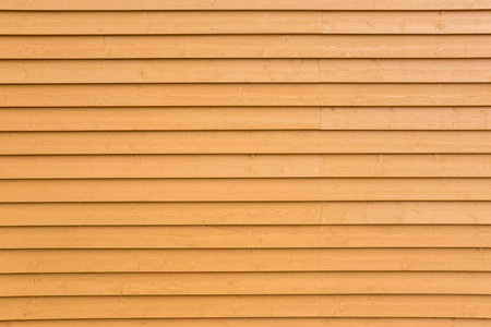 Background from a painted yellow plank wallの写真素材