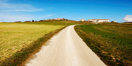 Country road up to little housesの写真素材