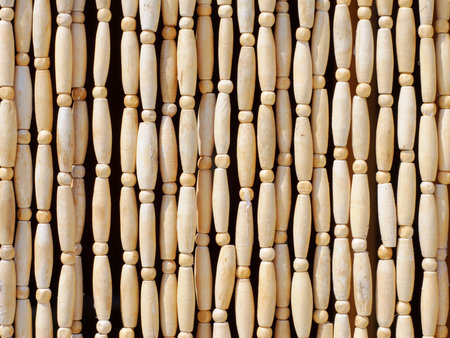 Natural patterns of wooden beeds hanging verticallyの写真素材