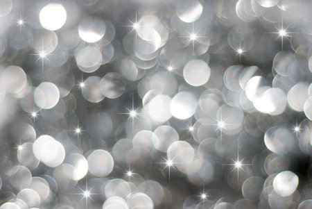 Glowing silver Christmas lights background with little stars