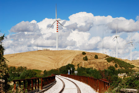Molise rural landscape with railroad, wind turbines and moody skyの写真素材