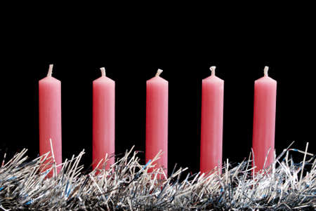 Row of new pink Christmas candles with silver glowing decorationの写真素材