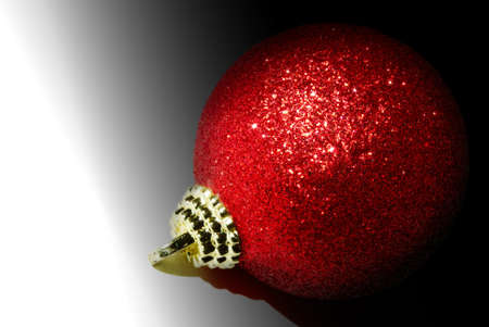 Red christmas ball glittering in the lightの写真素材
