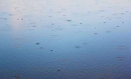 summer rain on the river.の写真素材