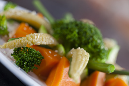Collection of sautéed vegetables in a white plate isolated on a white backgroundの写真素材
