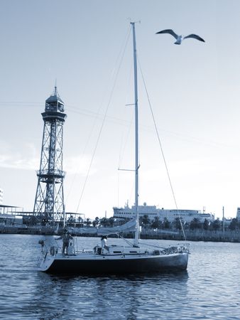 Barcelona port with ship and gull. With a blue toneの写真素材