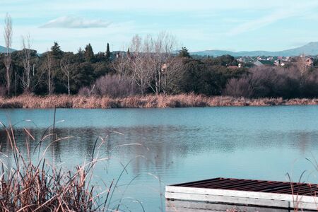 side view of a dock with a beautiful landscape on the backgroundの写真素材