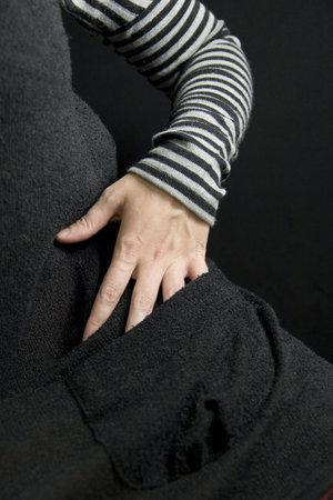 detail of a hand searching inside a pocket