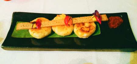 February, 2020. Abu Dhabi. Dahi kebab served on banana leaf and garnished with a crackerの写真素材