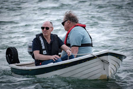 Auckland / New Zealand - October 20 2019: View of two older men riding motor dinghyのeditorial素材