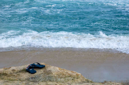 A pair of flip-flops on the beachの写真素材