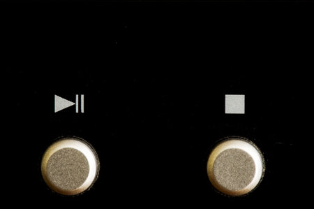 Close up of a play/pause and a stop button on digital equipment