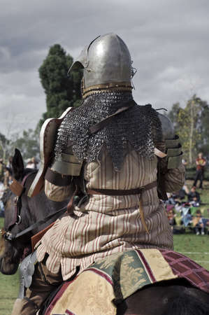Medieval knight sitting on his horse. From behind.の写真素材