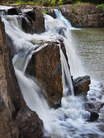 Close up image of a waterfall cascading over rocks.の写真素材