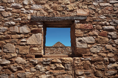 The view through the window of some stone ruins 